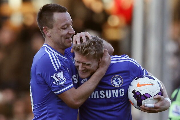 Chelsea's Andre Schurrle, right, and teammate John Terry celebrates his hat-trick goal against Fulham with the match ball at the end of their English Premier League soccer match at Craven Cottage, London, Saturday, March 1, 2014. (AP Photo/Sang Tan)