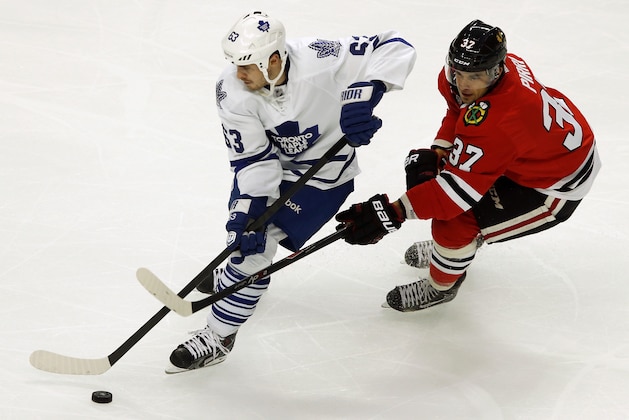 Toronto Maple Leafs center Dave Bolland (63) skates with the puck against Chicago Blackhawks center Brandon Pirri (37) during the third period of an NHL hockey game Saturday, Oct. 19, 2013, in Chicago. The Blackhawks won 3-1. (AP Photo/Andrew A. Nelles)