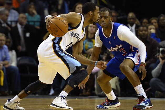 Feb 21, 2014; Memphis, TN, USA; Memphis Grizzlies point guard Mike Conley (11) dribbles the ball as Los Angeles Clippers point guard Chris Paul (3) defends at FedExForum. The Grizzlies won 102 - 96. Mandatory Credit: Justin Ford-USA TODAY Sports