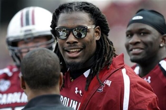 South Carolina defensive end Jadeveon Clowney talks with teammates on the sidelines during the second half of an NCAA college football game against Wofford, Saturday, Nov. 17, 2012, in Columbia, S.C.  Clowney did not dress out for the game after being injured. South Carolina defeated Wofford 24-7. (AP Photo/Stephen Morton)