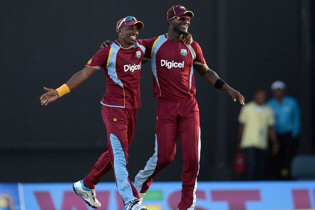 ANTIGUA, ANTIGUA AND BARBUDA - FEBRUARY 28:  Dwayne Bravo and Darren Sammy of the West Indies  celebrate winning the 1st One Day International between West Indies and England at Sir Viv Richards Cricket Ground on February 28, 2014 in Antigua, Antigua and Barbuda.  (Photo by Gareth Copley/Getty Images)