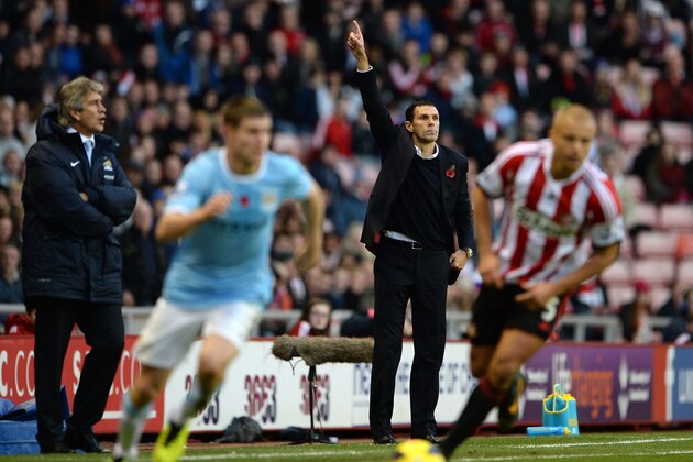 SUNDERLAND, ENGLAND - NOVEMBER 10:  Manager of Manchester City Manuel Pellegrini looks on as Manager of Sunderland Gus Poyet makes a point during the Barclays Premier League match between Sunderland and Manchester City at the Stadium of Light on November 10, 2013 in Sunderland, England.  (Photo by Michael Regan/Getty Images)