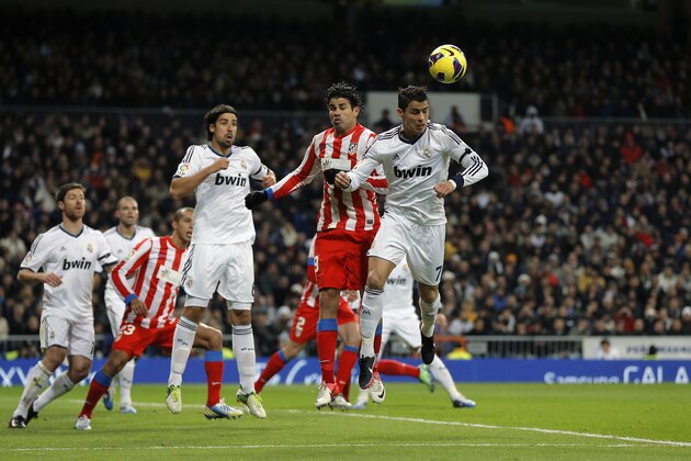 Real Madrid's Cristiano Ronaldo from Portugal, right, heads for the ball with Atletico de Madrid's Diego Costa during a Spanish La Liga soccer match at the Santiago Bernabeu stadium  in Madrid, Saturday, Dec. 1, 2012. (AP Photo/Daniel Ochoa de Olza)