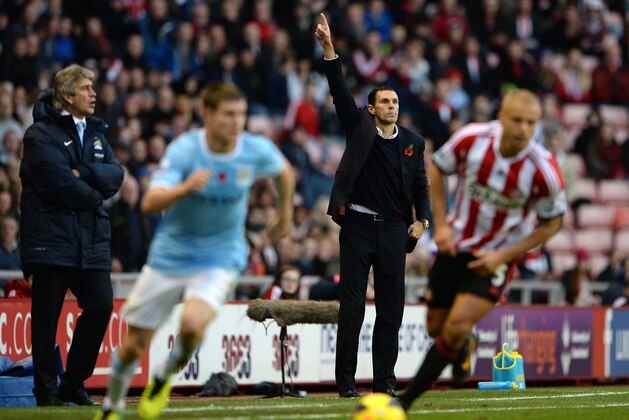 SUNDERLAND, ENGLAND - NOVEMBER 10: Manager of Manchester City Manuel Pellegrini looks on as Manager of Sunderland Gus Poyet makes a point during the Barclays Premier League match between Sunderland and Manchester City at the Stadium of Light on November 10, 2013 in Sunderland, England. (Photo by Michael Regan/Getty Images) SUNDERLAND, ENGLAND - NOVEMBER 10: Manager of Manchester City Manuel Pellegrini looks on as Manager of Sunderland Gus Poyet makes a point during the Barclays Premier League match between Sunderland and Manchester City at the Stadium of Light on November 10, 2013 in Sunderland, England. (Photo by Michael Regan/Getty Images)