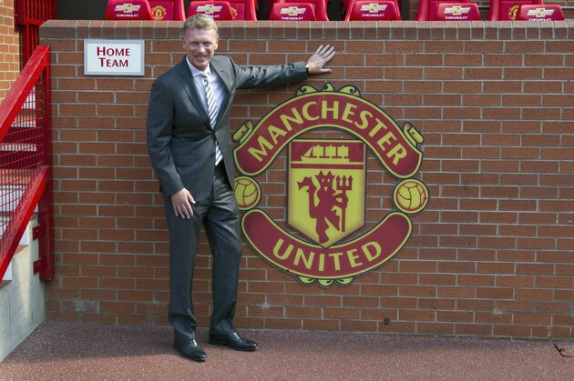 Manchester United's new manager David Moyes poses for pictures before a press conference at Old Trafford Stadium, Manchester, England, Friday July 5, 2013. Moyes took over officially on Monday from former manager Sir Alex Ferguson. (AP Photo/Jon Super)