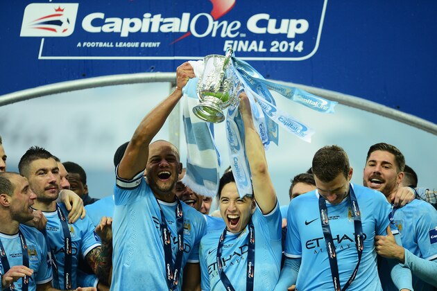 LONDON, ENGLAND - MARCH 02:  Vincent Kompany and Samir Nasri of Manchester City lift the trophy with team mates after the Capital One Cup Final between Manchester City and Sunderland at Wembley Stadium on March 2, 2014 in London, England.  (Photo by Jamie McDonald/Getty Images)