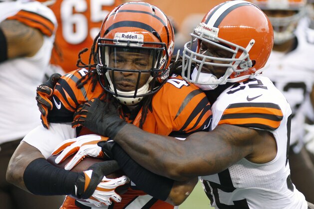 Cincinnati Bengals running back BenJarvus Green-Ellis, left, is tackled by Cleveland Browns inside linebacker D'Qwell Jackson, right, during the first half of an NFL football game, Sunday, Nov. 17, 2013, in Cincinnati. (AP Photo/David Kohl)