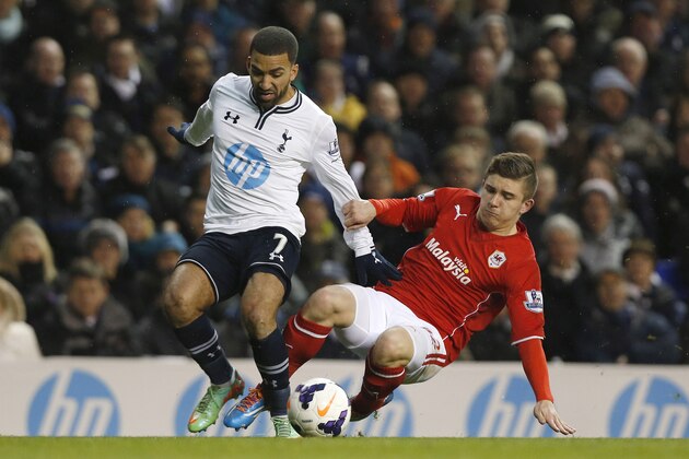 Tottenham Hotspur's Aaron Lennon, left, is tackled by Cardiff City's Declan John during their English Premier League soccer match at White Hart Lane, London, Sunday, March 2, 2014. (AP Photo/Sang Tan)