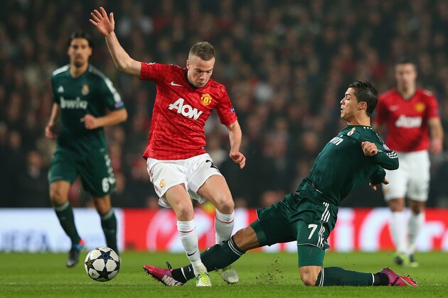 MANCHESTER, ENGLAND - MARCH 05:  Tom Cleverley of Manchester United is challenged by Cristiano Ronaldo of Real Madrid during the UEFA Champions League Round of 16 Second leg match between Manchester United and Real Madrid at Old Trafford on March 5, 2013 in Manchester, United Kingdom.  (Photo by Alex Livesey/Getty Images)