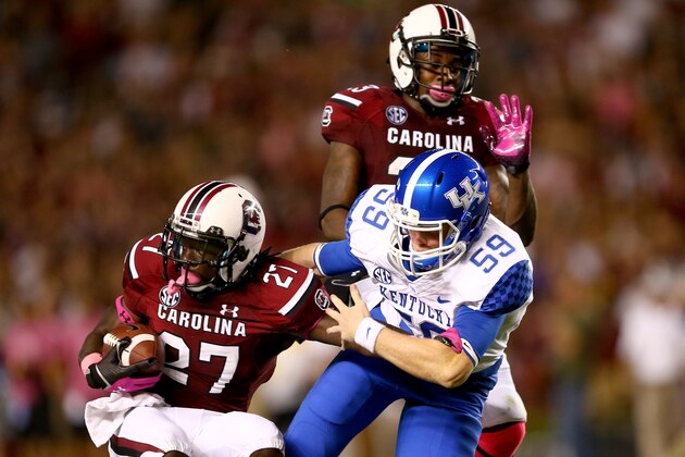 COLUMBIA, SC - OCTOBER 05:  Kelly Mason #59 of the Kentucky Wildcats stops Victor Hampton #27 of the South Carolina Gamecocks during their game at Williams-Brice Stadium on October 5, 2013 in Columbia, South Carolina.  (Photo by Streeter Lecka/Getty Images)