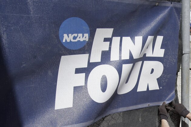 Workers put up a banner outside for the NCAA Final Four college basketball tournament game Wednesday, March 31, 2010, in Indianapolis. (AP Photo/Michael Conroy)