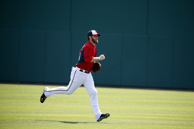 Washington Nationals left fielder Bryce Harper (34) jogs back to the dugout in a spring exhibition baseball game against the Atlanta Braves, Saturday, March 1, 2014, in Viera, Fla. (AP Photo/Alex Brandon)