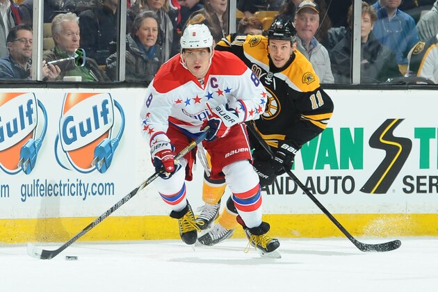 BOSTON, MA - MARCH 1: Alex Ovechkin #8 of the Washington Capitals skates with the puck against Gregory Campbell #11 of the Boston Bruins at the TD Garden on March 1, 2014 in Boston, Massachusetts.  (Photo by Steve Babineau/NHLI via Getty Images)