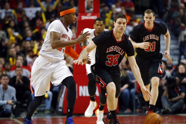 Newly signed Chicago Bulls guard Jimmer Fredette dribbles past New York Knicks guard Toure' Murry during the second half of an NBA basketball game on Sunday, March 2, 2014, in Chicago. The Bulls won 109-90. (AP Photo/Jeff Haynes)