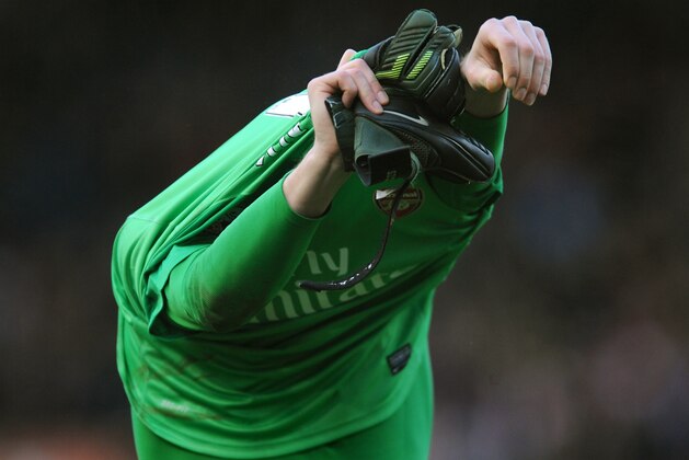 Arsenal goalkeeper Wojciech Szczesny removes his shirt after the English Premier League soccer match between Stoke City and Arsenal at Britannia Stadium in Stoke On Trent, England, Saturday, March 1, 2014. (AP Photo/Rui Vieira)
