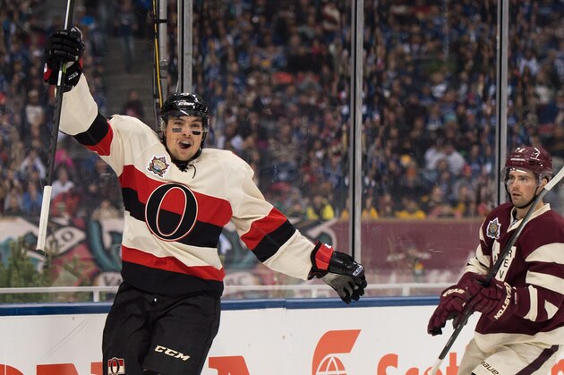 Ottawa Senators' Cody Ceci, left, celebrates after scoring a goal as Vancouver Canucks' Dan Hamhuis looks on during second period NHL hockey action at the Heritage Classic at B.C. Place stadium in Vancouver, B.C., Sunday, March 2, 2014. (AP Photo/The Canadian Press, Jonathan Hayward)