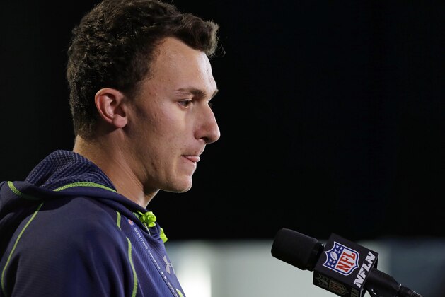 Texas A&M quarterback Johnny Manziel answers a question during a news conference at the NFL football scouting combine in Indianapolis, Friday, Feb. 21, 2014. (AP Photo/Michael Conroy)