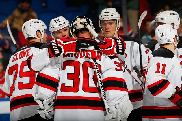 UNIONDALE, NY - MARCH 01: Martin Brodeur #30 of the New Jersey Devils celebrates with his teammates after defeating the New York Islanders at Nassau Veterans Memorial Coliseum on March 1, 2014 in Uniondale, New York. The Devils defeated the Islanders 6-1.  (Photo by Mike Stobe/NHLI via Getty Images)