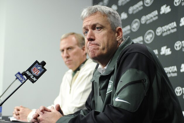New York Jets coach Rex Ryan, right, reacts as he and general manager John Idzik speak to the media  during an NFL football news conference Tuesday, Dec. 31, 2013, in Florham Park, N.J. (AP Photo/Bill Kostroun)