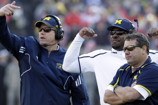 Michigan head coach Brady Hoke, right, watches from the sidelines during the second half of an NCAA college football game against Ohio State in Ann Arbor, Mich., Saturday, Nov. 30, 2013. (AP Photo/Carlos Osorio)
