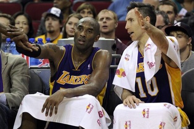 Los Angeles Lakers Kobe Bryant, left, and Steve Nash talk on the bench in the final two minutes of an NBA basketball game against the Houston Rockets Tuesday, Jan. 8, 2013, in Houston. The Rockets won 125-112. (AP Photo/Pat Sullivan)