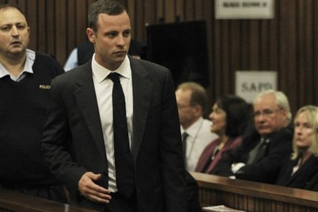 Oscar Pistorius is watched by June Steenkamp, right, the mother of Reeva Steenkamp, as he arrives for his trial at the high court in Pretoria, South Africa, Monday, March 3, 2014. Pistorius is charged with murder with premeditation in the shooting death of girlfriend Reeva Steenkamp in the pre-dawn hours of Valentine's Day 2013. (AP Photo/Themba Hadebe, Pool)