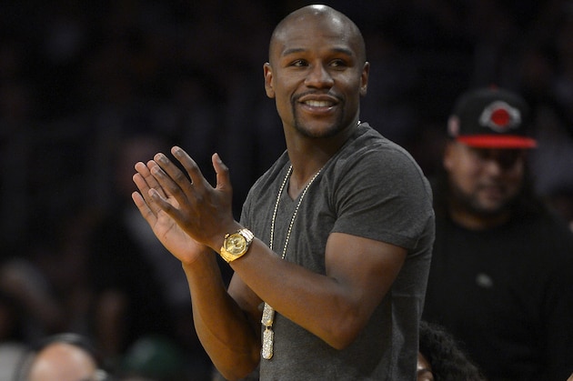 Boxer Floyd Mayweather watches the Los Angeles Lakers play the Boston Celtics during the second half of an NBA basketball game, Friday, Feb. 21, 2014, in Los Angeles. (AP Photo/Mark J. Terrill)