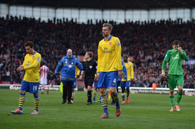 STOKE ON TRENT, ENGLAND - MARCH 01:  Per Mertesacker of Arsenal and his team-mates look dejected at the end of the Barclays Pemier League match between Stoke City and Arsenal at the Britannia Stadium on March 1, 2014 in Stoke on Trent, England.  (Photo by Michael Regan/Getty Images)