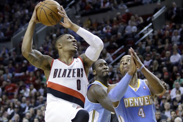 Portland Trail Blazers guard Damian Lillard, left, drives to the basket against Denver Nuggets' Randy Foye, right, and J.J. Hickson during the second half of an NBA basketball game in Portland, Ore., Saturday, March 1, 2014.  Lillard scored 17 points as they beat the Nuggets 102-96. (AP Photo/Don Ryan)