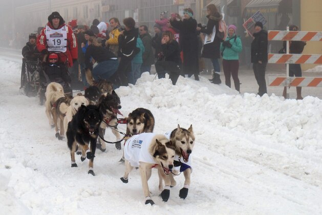 Defending champion Dallas Seavey takes off Saturday, March 2, 2013, in downtown Anchorage, Alaska, for the ceremonial start of the 2013 Iditarod Trail Sled Dog Race. The race, which will take mushers and dog teams about a thousand miles across the Alaska wilderness, starts Sunday, March 3, 2013, in Willow, Alaska. (AP Photo/Mark Thiessen)