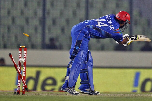 Afghanistan’s Asghar Stanikzai is bowled out by Sri Lanka’s Thisara Perera during the Asia Cup one-day international cricket tournament between them in Dhaka, Bangladesh, Monday, March 3, 2014. (AP Photo/A.M. Ahad)