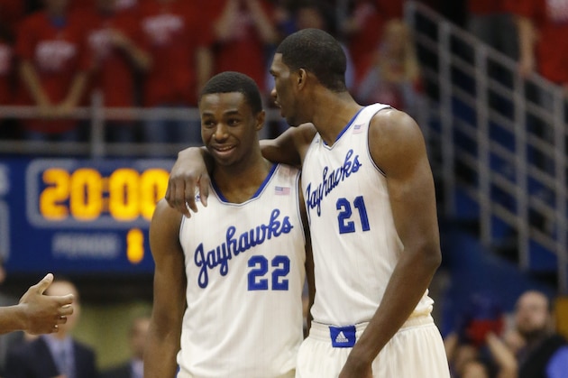 Kansas guard Andrew Wiggins (22) and center Joel Embiid (21) during the first half of an NCAA college basketball game against Oklahoma State at Allen Fieldhouse in Lawrence, Kan., Saturday, Jan. 18, 2014. (AP Photo/Orlin Wagner)