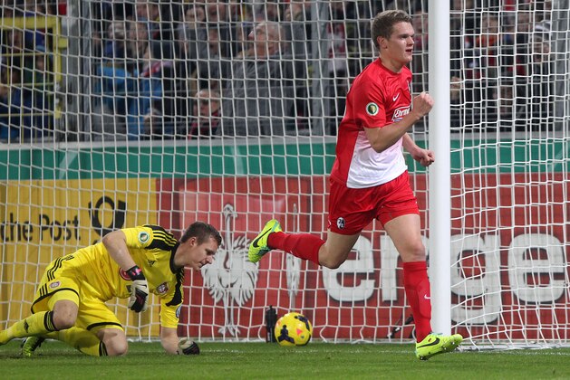 Freiburg's Matthias Ginter celebrates his side's opening goal during a round of 16 German soccer cup match between SC Freiburg and Bayer Leverkusen in Freiburg, Germany, Wednesday, Dec. 4, 2013. (AP Photo/Michael Probst)