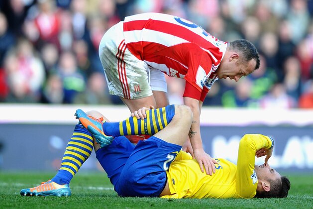 STOKE ON TRENT, ENGLAND - MARCH 01: Olivier Giroud of Arsenal is consoled by Charlie Adam of Stoke City during the Barclays Premier League match between Stoke City and Arsenal at Britannia Stadium on March 1, 2014 in Stoke on Trent, England.  (Photo by Laurence Griffiths/Getty Images)