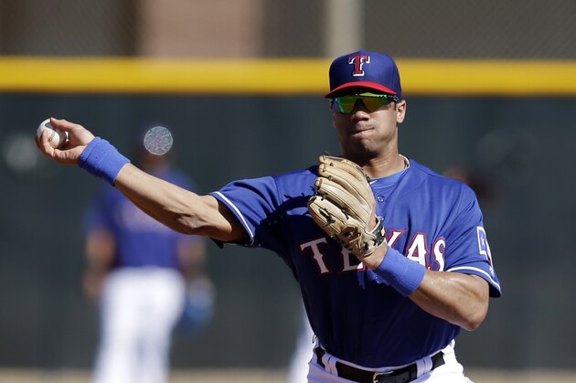 Seattle Seahawks quarterback Russell Wilson throws to first after fielding a ground ball during spring training baseball practice, Monday, March 3, 2014, in Surprise, Ariz. (AP Photo/Tony Gutierrez)