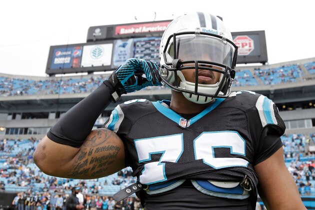 Carolina Panthers' Greg Hardy (76) straps on his helmet following stretching before an NFL football game against the New Orleans Saints in Charlotte, N.C., Sunday, Dec. 22, 2013. The Panthers won 17-13. (AP Photo/Bob Leverone)