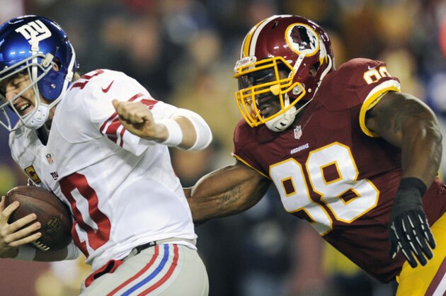 FILE - in this Dec. 1, 2013 file photo, New York Giants quarterback Eli Manning, left, is sacked by Washington Redskins outside linebacker Brian Orakpo (98) during the first half of an NFL football game in Landover, Md. The Redskins have used their franchise tag on three-time Pro Bowl linebacker  Orakpo, all but ensuring he will remain with the team next season. The Redskins used the non-exclusive tag Monday, March 3, 2014, on Orakpo.  (AP Photo/Nick Wass, File)