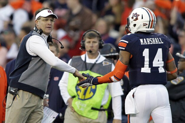 Nov 30, 2013; Auburn, AL, USA; Auburn Tigers head coach Gus Malzahn high fives quarterback Nick Marshall (14) during the second quarter at Jordan Hare Stadium. Mandatory Credit: John Reed-USA TODAY Sports