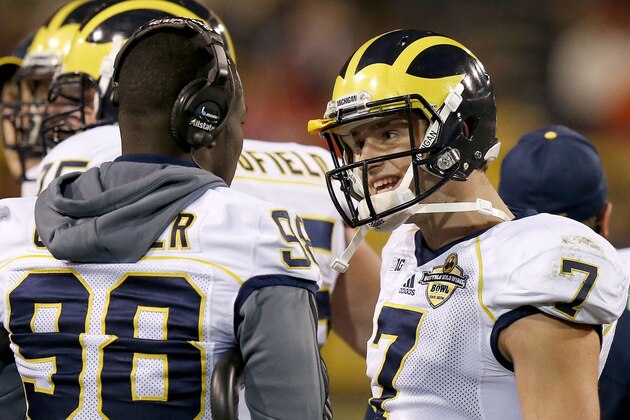 Michigan's Shane Morris (7) talks things over with injured quarterback Devin Gardner (98) during a timeout in the first half of the Buffalo Wild Wings Bowl NCAA college football game against Kansas State Saturday, Dec. 28, 2013, in Tempe, Ariz. (AP Photo/Ross D. Franklin)