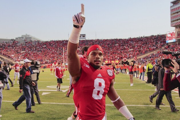 Nebraska running back Ameer Abdullah (8) gestures to fans in the stands following an NCAA college football game against Northwestern in Lincoln, Neb., Saturday, Nov. 2, 2013. Nebraska won 27-24. (AP Photo/Nati Harnik)