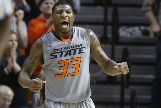 Oklahoma State guard Marcus Smart (33) celebrates during the second half of an NCAA college basketball game against Kansas in Stillwater, Okla., Saturday, March 1, 2014. Oklahoma State won 72-65. (AP Photo/Sue Ogrocki)