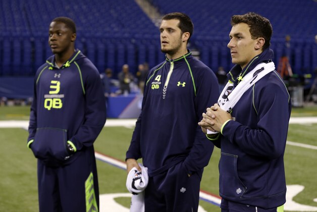 Texas A&M quarterback Johnny Manziel, right, Fresno State quarterback Derek Carr, center, and Louisville quarterback Teddy Bridgewater watch drills at the NFL football scouting combine in Indianapolis, Sunday, Feb. 23, 2014. (AP Photo/Michael Conroy)