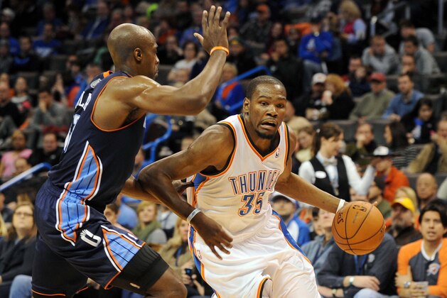Mar 2, 2014; Oklahoma City, OK, USA; Oklahoma City Thunder small forward Kevin Durant (35) handles the ball against Charlotte Bobcats power forward Anthony Tolliver (43) during the fourth quarter at Chesapeake Energy Arena. Mandatory Credit: Mark D. Smith-USA TODAY Sports