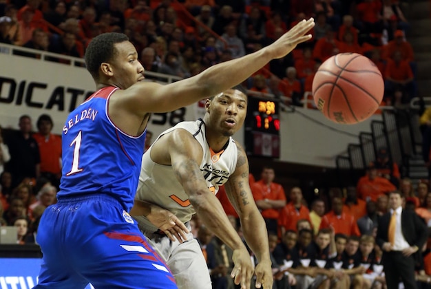 Mar 1, 2014; Stillwater, OK, USA; Oklahoma State Cowboys guard Marcus Smart (33) passes against Kansas Jayhawks guard Wayne Selden, Jr. (1) during the first half  at Gallagher-Iba Arena. Oklahoma State beat Kansas 72-65. Mandatory Credit: Tim Heitman-USA TODAY Sports