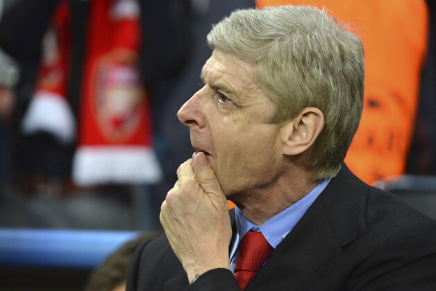 Arsenal manager Arsene Wenger waits for the beginning of the Champions League round of 16 second leg soccer match between FC Bayern Munich and FC Arsenal in Munich, Germany, Wednesday, March 13, 2013. (AP Photo/Kerstin Joensson)