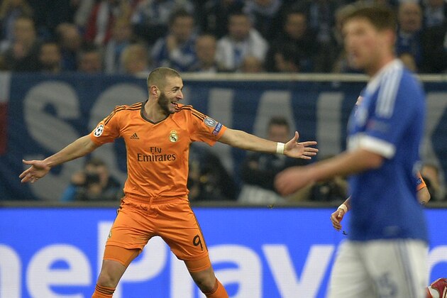Real's Karim Benzema, left, celebrates scoring his side's first goal during a Champions League round of sixteen, first leg soccer match between Schalke 04 and Real Madrid at the Veltins Arena in Gelsenkirchen, Germany, Wednesday Feb. 26, 2014. (AP Photo/Martin Meissner)