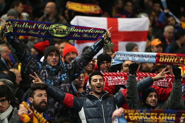 MANCHESTER, ENGLAND - FEBRUARY 18:  Barcelona fans celebrate during the UEFA Champions League Round of 16 first leg match between Manchester City and Barcelona at the Etihad Stadium on February 18, 2014 in Manchester, England.  (Photo by Clive Brunskill/Getty Images)