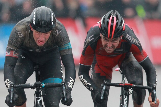 Britain's Ian Stannard of the Sky team, left, sprints to win, with Belgium's Greg Van Avermaet, right, of the BMC Racing team taking second place in the Omloop Het Nieuwsblad cycling classic, traditionally the Belgian opener of the cycling season, in Ghent, western Belgium, Saturday, March 1, 2014.  Norway's Edvald Boasson Hagen of the Sky team placed third. (AP Photo/Yves Logghe)