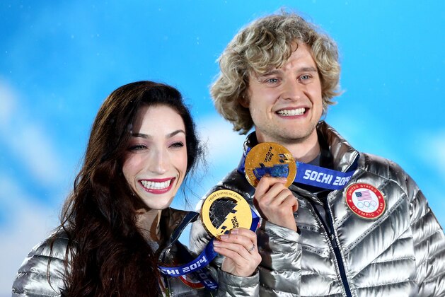SOCHI, RUSSIA - FEBRUARY 18:  Gold medalists Meryl Davis (L) and Charlie White of the United States celebrate during the medal ceremony for the Figure Skating Ice Danceon day 11 of the Sochi 2014 Winter Olympics at Medals Plaza on February 18, 2014 in Sochi, Russia.  (Photo by Ryan Pierse/Getty Images)