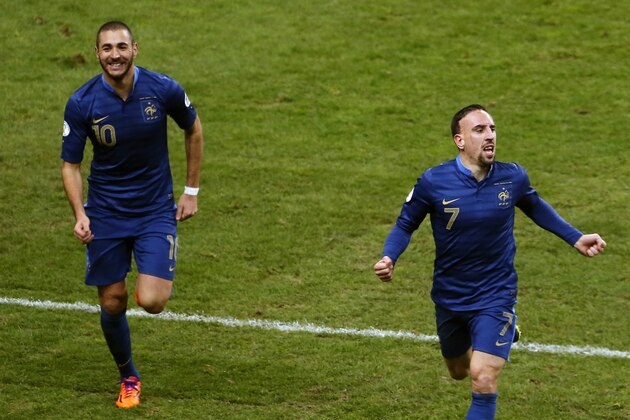 France's Karim Benzema, left, and Franck Ribery, celebrate after Mamadou Sakho scores, during the World Cup qualifying playoff second-leg soccer match between France and Ukraine at Stade de France stadium, in Saint Denis, outside Paris, Tuesday, Nov. 19, 2013. France beats Ukraine 3-0 in playoff second leg to qualify for World Cup. (AP Photo/Thibault Camus)